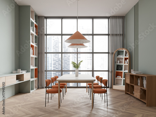 Green dining room interior with bookcase