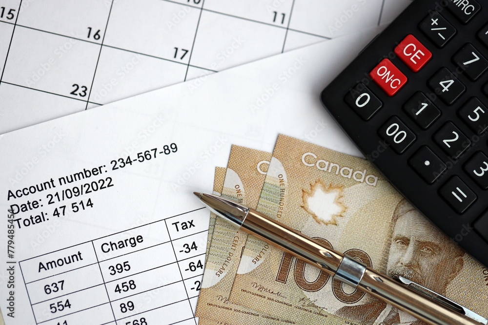 Obraz premium Many calculation results in schedules lies on table with canadian money bills, calculator and pen close up. Taxation and annual accountant paperwork in Canada