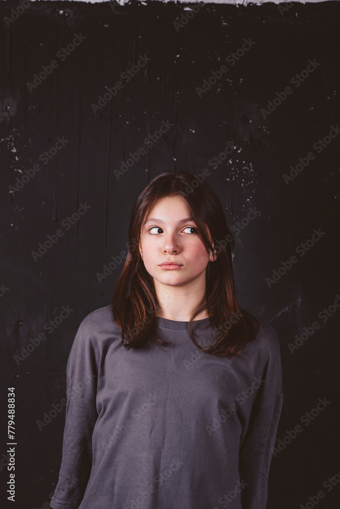 Girl with sideways glance in front of black background Girl with sideways glance in front of black background