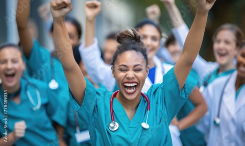 Diverse group of medical professionals cheering and celebrating together