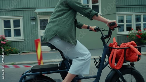 Wallpaper Mural Cute young woman in casual outfit ride fun small electric city bike with a front rack for bags and groceries. Urban mobility and green transportation for cities. No cars, bike friendly street Torontodigital.ca