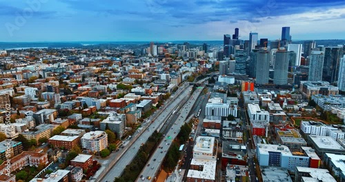 Cars ride quickly by the highways in the downtown of Seattle, Washington, United States. Vast cityscape from drone footage at dusk. photo