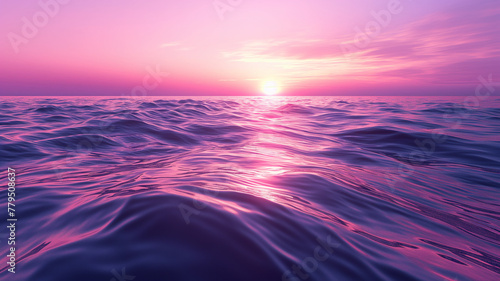 The ocean is a deep blue color with a pink sunset in the background