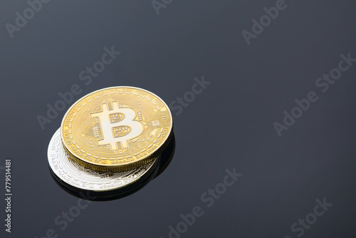 Golden and silver bitcoin cryptocurrency on black background