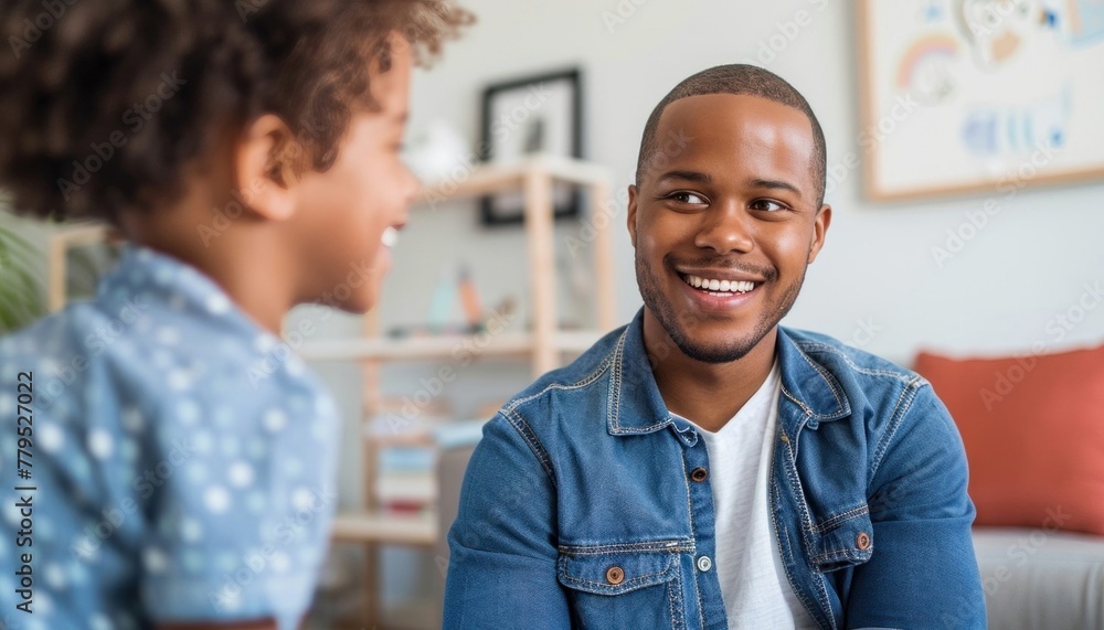 Joyful African American father bonding with son in cozy living room Joyful African American father bonding with son in cozy living room