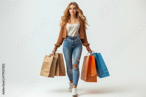 A woman is walking with a shopping bag in each hand