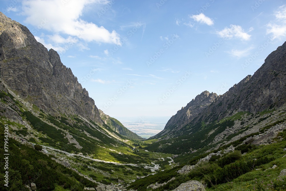 Breathtaking view of a green valley surrounded by rocky cliffs in the High Tatras range in Slovakia