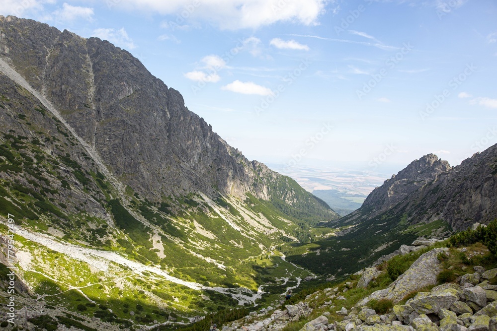 High-angle shot of little Tarpataki valley with sunlight on and blue sky in the background High-angle shot of little Tarpataki valley with sunlight on and blue sky in the background