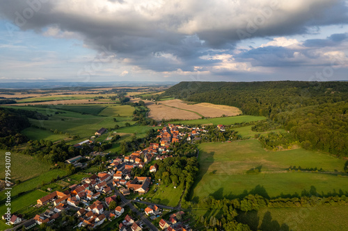 Obraz na płótnie Aer ial view of a German village surrounded by meadows, farmland and forest. Thuringia, Germany. w salonie