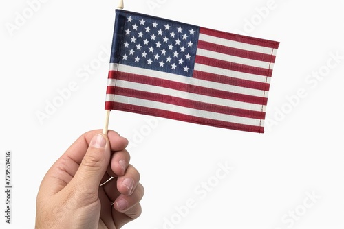 Hand holding an American flag isolated on a white background. 