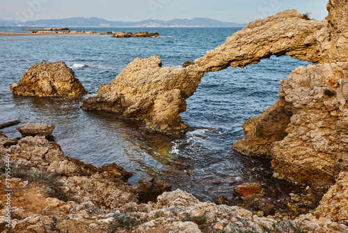 Natural stone arch. Mediterranean coast at Lescala, Empuries. Catalonia, Spain photo
