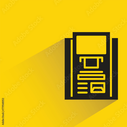 atm with shadow on yellow background