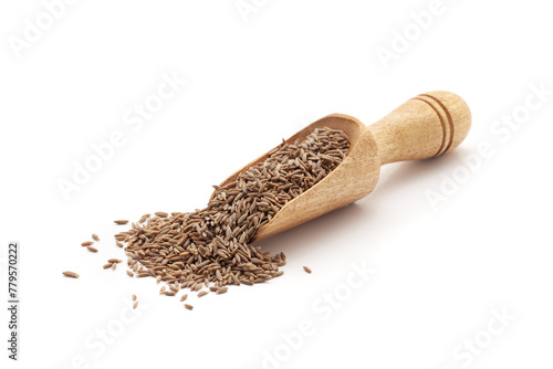 Front view of a wooden scoop filled with Organic Cumin Seeds (Cuminum cyminum) or jeera. Isolated on a white background.