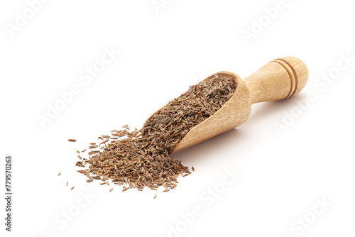 Front view of a wooden scoop filled with Organic Caraway seeds (Carum carvi). Isolated on a white background.