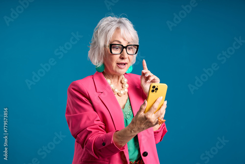 Senior Woman with Smartphone Having an Aha Moment photo