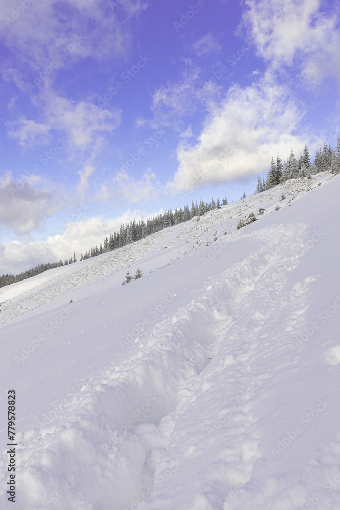 the path paved in deep snow in the mountains in winter. winter hike, journey, good winter weather
