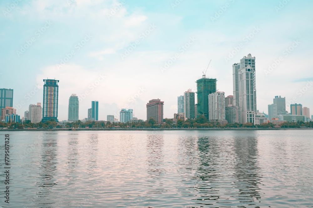 Naklejka premium Calm waters of the sea with the buildings of Manila City of the Philippines in the background