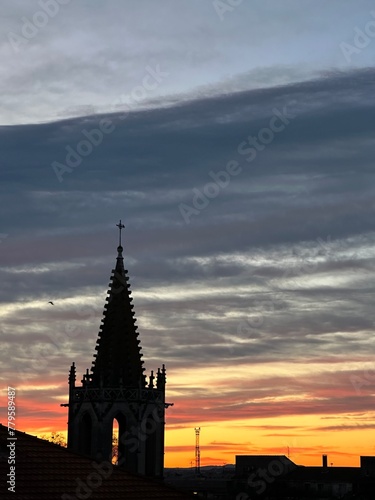 A church with a cross on the top against the sunrise sky in Avignon, Provence-Alpes-Côte d'Azur, France, February 2023