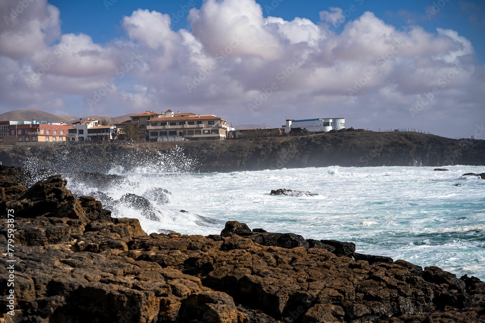 Beautiful shot of waves hitting the rugged rocky beach of El Cotillo, in Fuerteventura Spain
