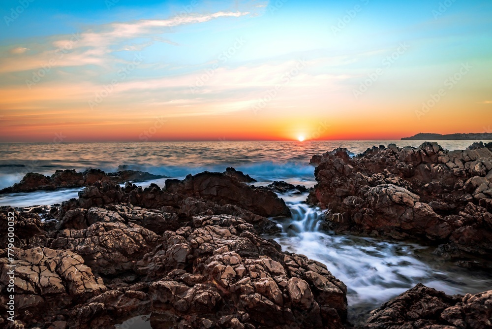 Beautiful view of a rocky shore under the blue sky during sunset