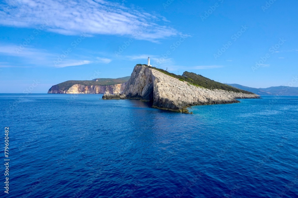 Beautiful view of a cliff surrounded by a blue calm sea
