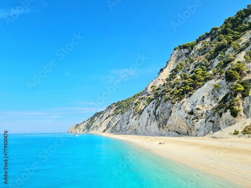 Vertical shot of a rocky island under the cloudy sky