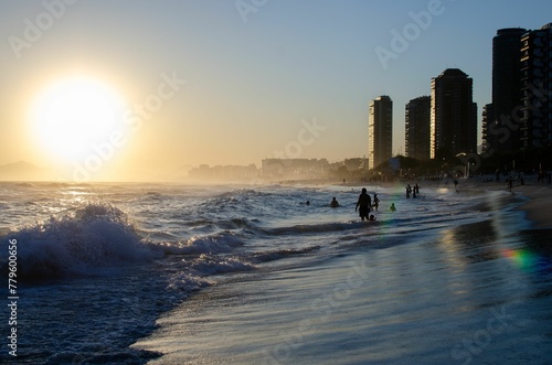 Scenic shot of beach with sea waves in Barra da Tijuca at sunset, Rio de Janerio photo