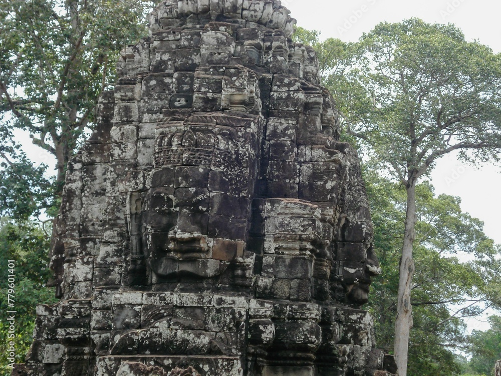 Image of a stone statue in front of trees in Angkor Wat, Cambodia