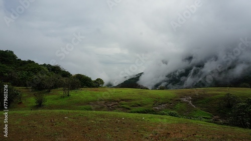 Beautiful foggy landscape of mountain range in the countryside covered in clouds