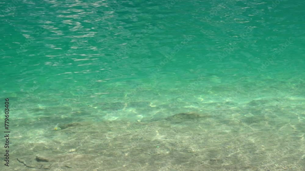 Shallow turquoise waves of lake Braies in the Dolomites Shallow turquoise waves of lake Braies in the Dolomites