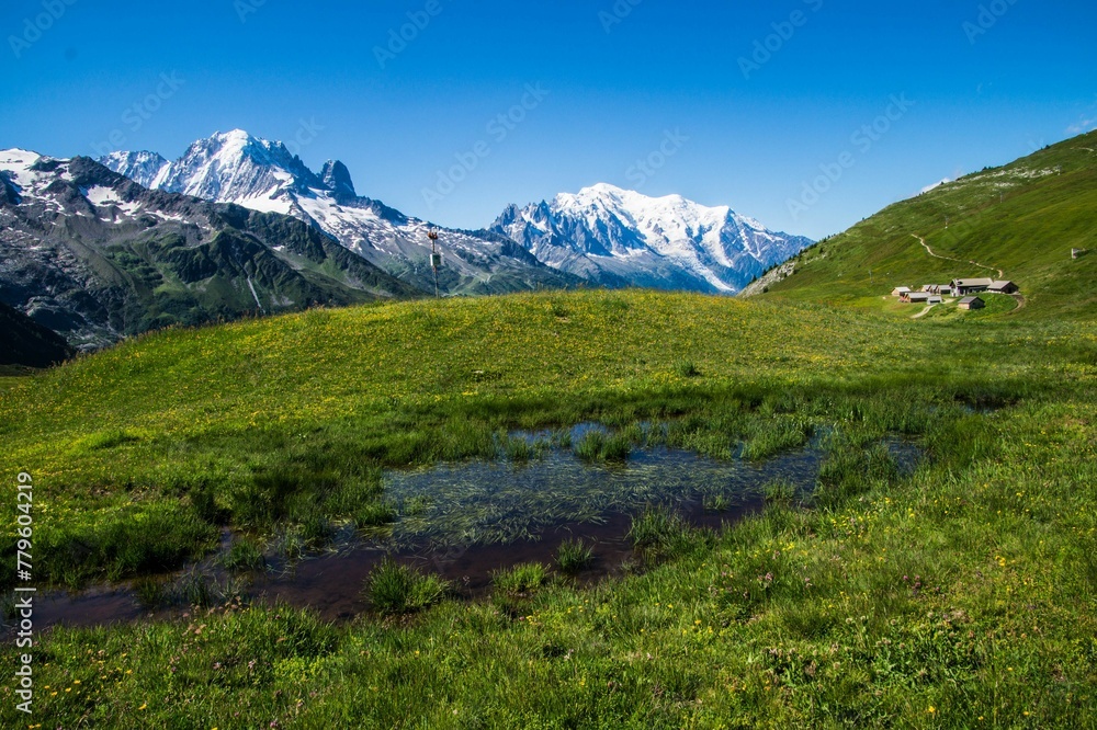 Fototapeta premium Landscape of wet grass hills and houses in charamillon gondola alps in Haute Savoie, France