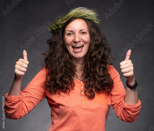 Smiling happy woman with wreath on head posing in studio