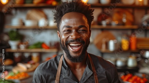 Joyful cook dancing in the kitchen. Cheerful man in an apron smiling while cooking or baking