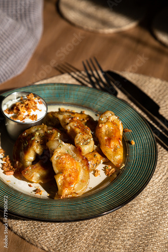 Fried dumplings with sour cream and crispy onions
