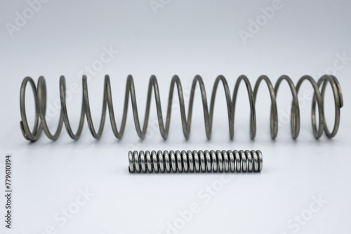 Two metal springs. White background. Іhallow depth of field. photo