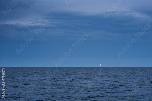 Lonely sailboat in the sea at a stormy weather © Mikhail Mishchenko
