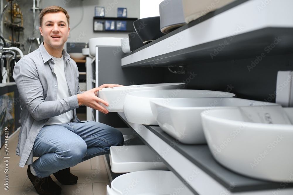 Man choosing a batgh sink with sales person Man choosing a batgh sink with sales person