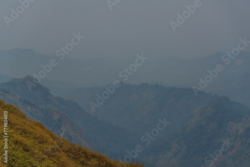 The sky is hazy and the mountains are in the background