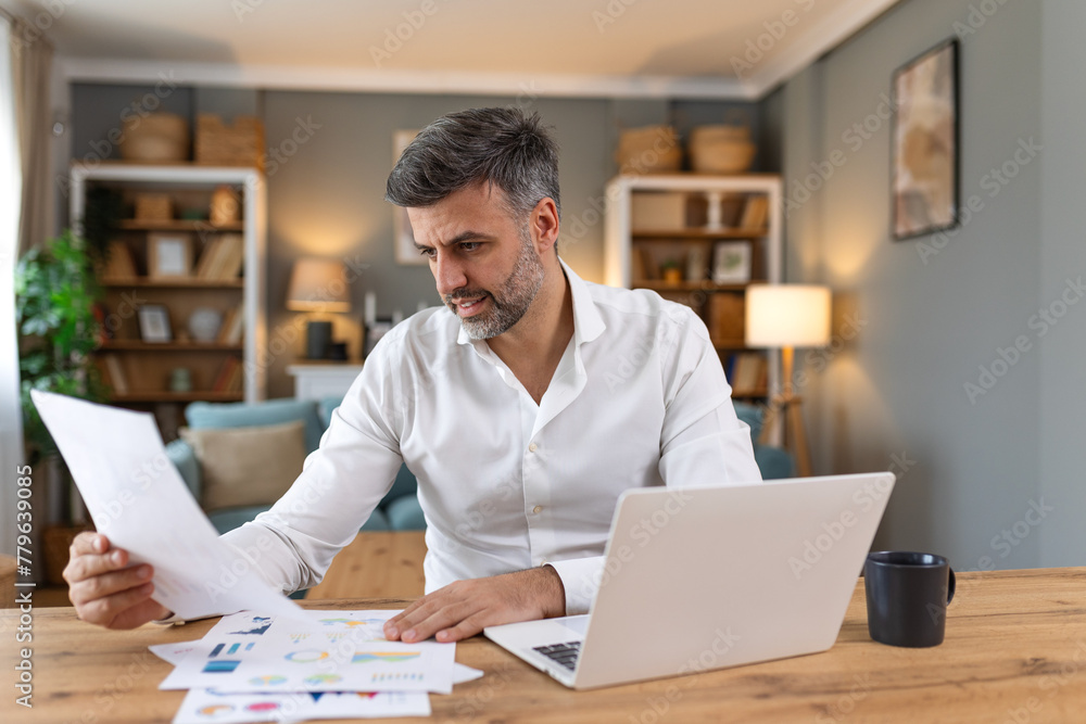 Business professionals. Business man analyzing data using computer while spending time in the office. Young grinning professional man in office. Graphs and charts Business professionals. Business man analyzing data using computer while spending time in the office. Young grinning professional man in office. Graphs and charts