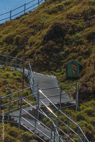 A staircase leads up to a green shed