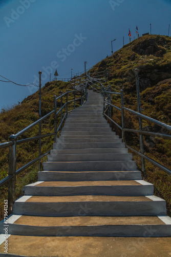 A staircase with a railing and a blue sky in the background