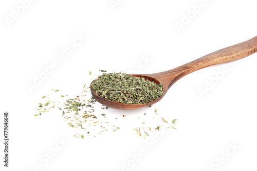 Dried thyme herb on wooden spoon and on white background.