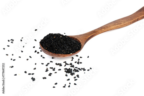 Black sesame seeds on wooden spoon on white background.