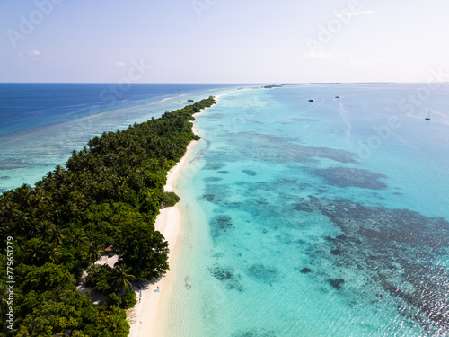 Aerial view of the Dhigurah island in the Maldives famous for its long white sand beach lined with palm trees in the south Ari atoll photo