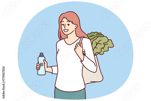 Woman with reusable eco shopping bag and recycled plastic bottle returns from farmer vegetable market. Girl takes care of environment by refusing to use plastic packaging that pollutes nature