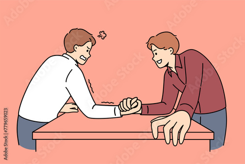 Two men engage in arm wrestling to find out who is stronger and prove own leadership in business team. Friends do comic am-wrestling, demonstrating athletic superiority to opponent