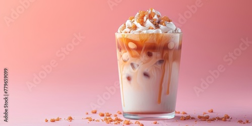Iced caramel latte, macchiato, coffee with whipped cream and caramel syrup in glass with ice cubes on pastel pink background, copy space photo