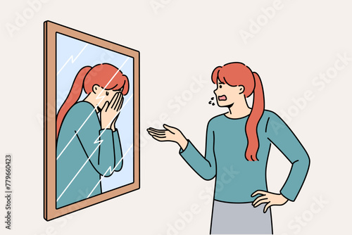 Woman scolds own reflection in mirror, for concept of low self-esteem and problems with having self-confidence. Split personality and lack of self-esteem causes disorder or nervous breakdowns