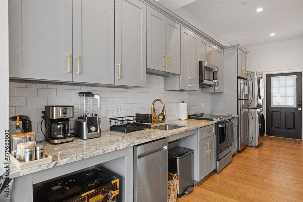 Modern grey kitchen cabinets with elegant gold hardware on doors and ...