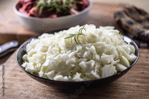 Bowl of sliced organic white onions on Wooden background © weyo
